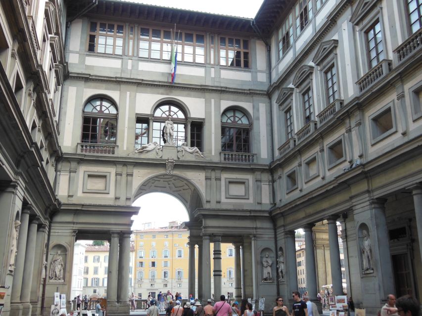 Florence: Walking Tour with Accademia & Uffizi Galleries - Walking toward Ponte Vecchio via the Vasari Corridor area